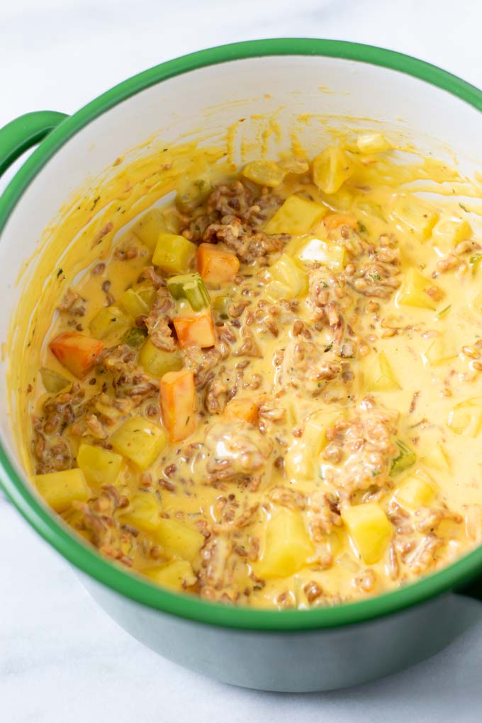 Closeup of the Cheeseburger Soup in a large pot.