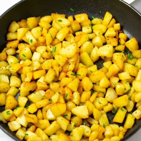 Country Potatoes are garnished with fresh chives.