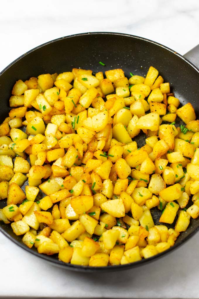 Country Potatoes are garnished with fresh chives. 