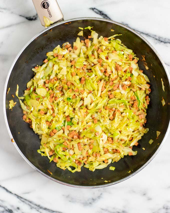 Top view of a large frying pan with the ready Fried Cabbage.