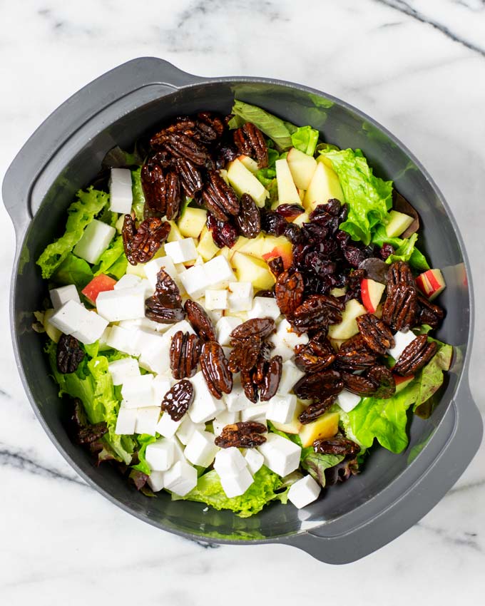 Top view of a large mixing bowl with all Apple Salad ingredients. 