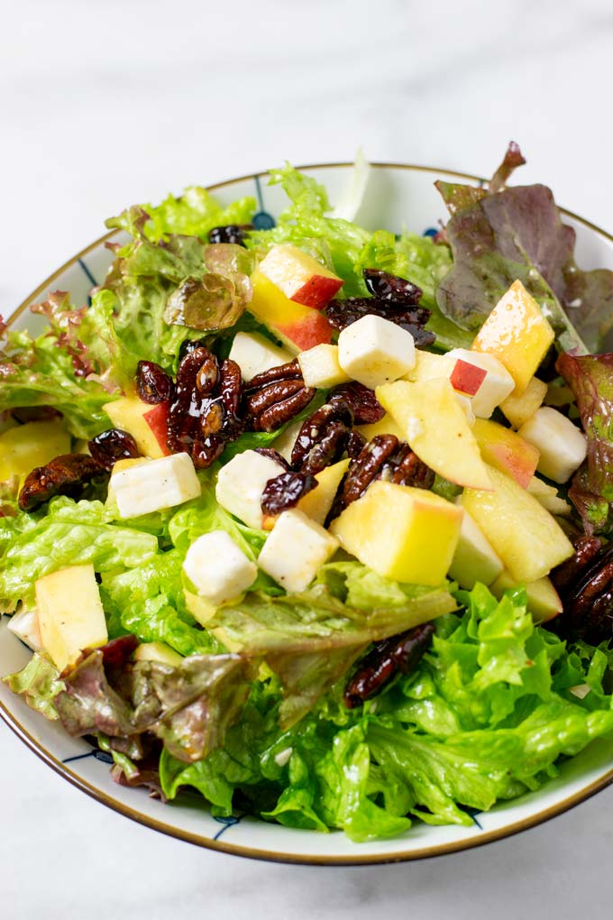 The Apple Salad is given into a serving bowl.