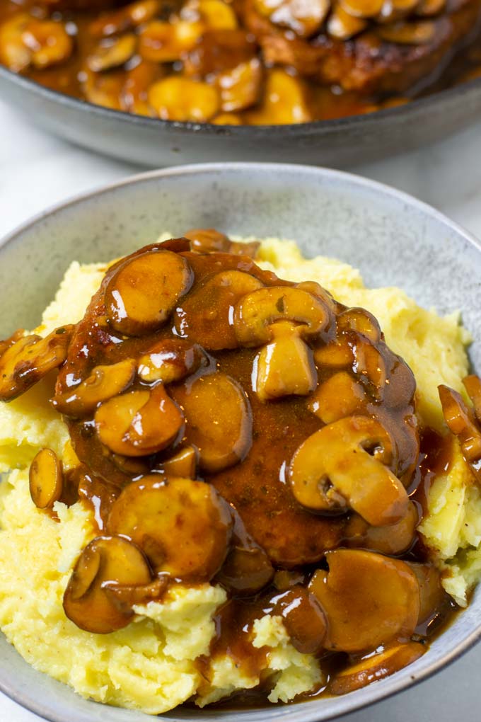 Closeup of a portion of the Salisbury Steak served with mashed potatoes.