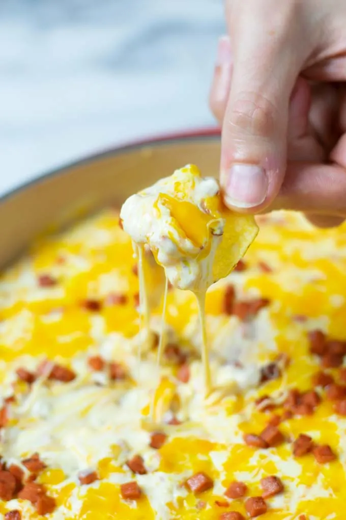 Dipping a potato chip into the Hot Cheese Dip.