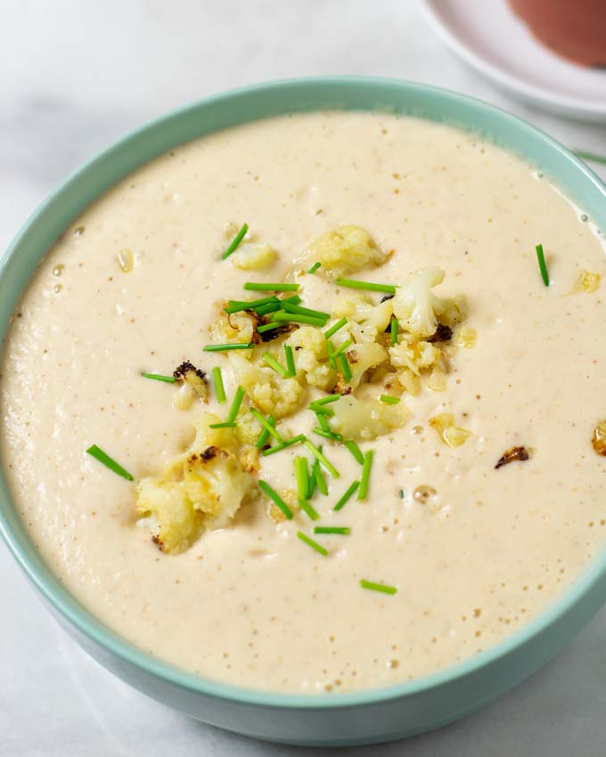 A large bowl of the Roasted Cauliflower Soup in a bowl.