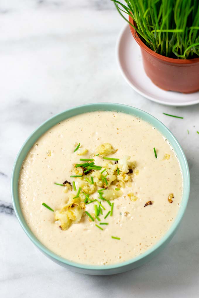 Extra roasted cauliflower is used to garnish the soup.
