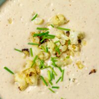 Closeup of the roasted Cauliflower Soup with cauliflower and chives topping.