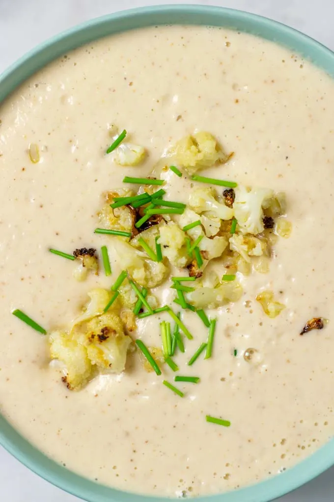 Closeup of the roasted Cauliflower Soup with cauliflower and chives topping.