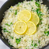 Four thin slices of lemon are used to garnish the Lemon Rice in the pan.