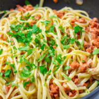 Closeup on the fresh green parsley topping with the linguine.