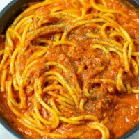 Closeup of a pan with the Pomodoro Sauce mixed with pasta.