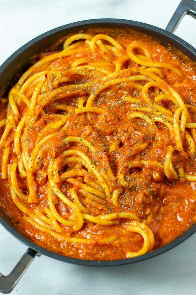 Closeup of a pan with the Pomodoro Sauce mixed with pasta.