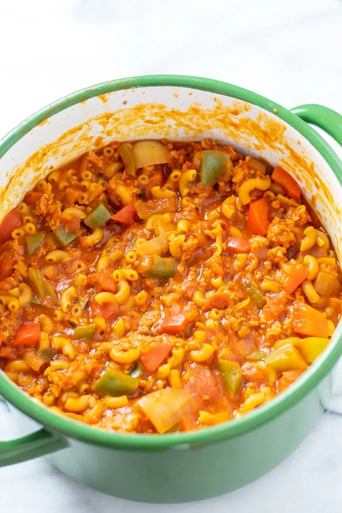 Looking from the side onto the American Goulash in a large green pot.