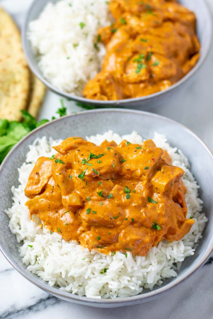 Two plate of served Butter Chicken.