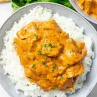 Top view on a plate with Butter Chicken over Basmati rice.