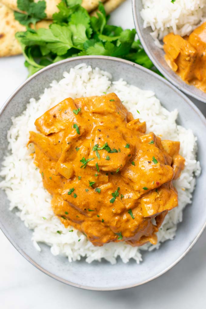 Top view on a plate with Butter Chicken over Basmati rice.
