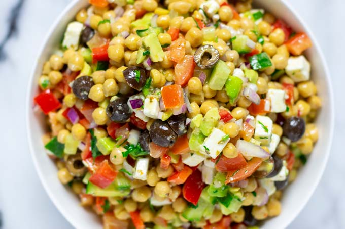 Closeup pf the Chickpea Salad in a large white serving bowl.