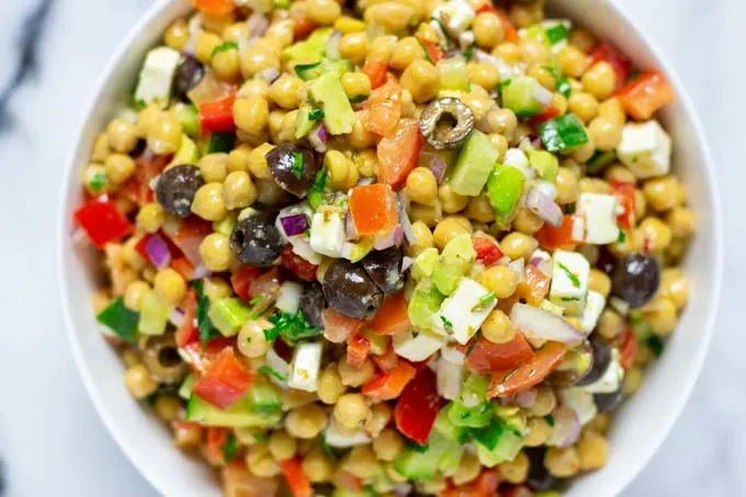 Closeup pf the Chickpea Salad in a large white serving bowl.