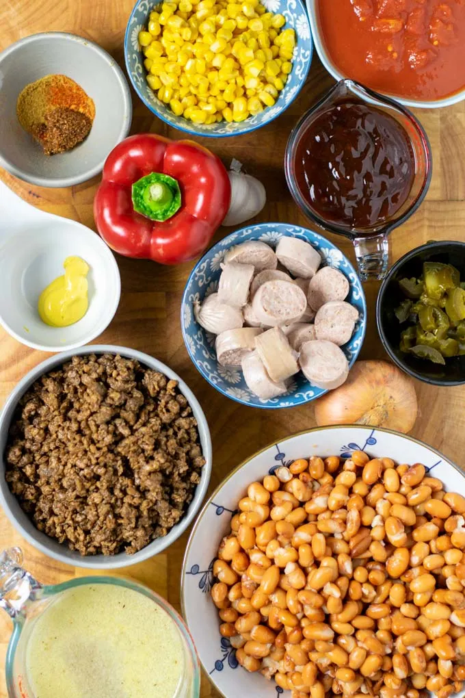 Ingredients needed to make the Cowboy Stew assembled on a wooden board.