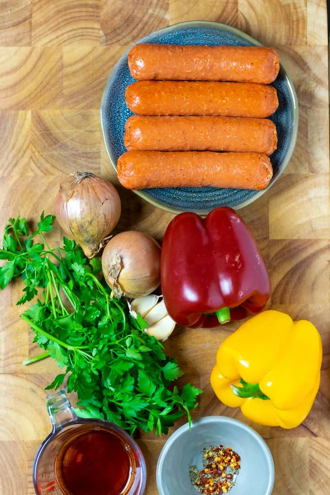Ingredients for the Sausage and Peppers are assembled on a wooden board.