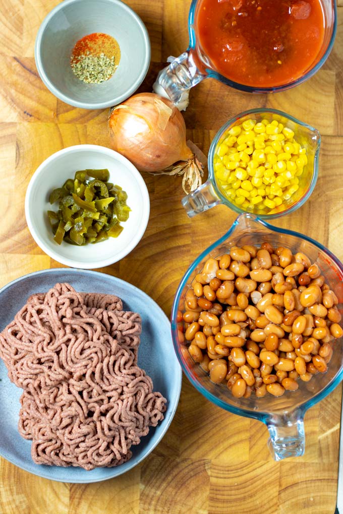 Ingredients needed to make the Taco Soup are collected on a wooden board.