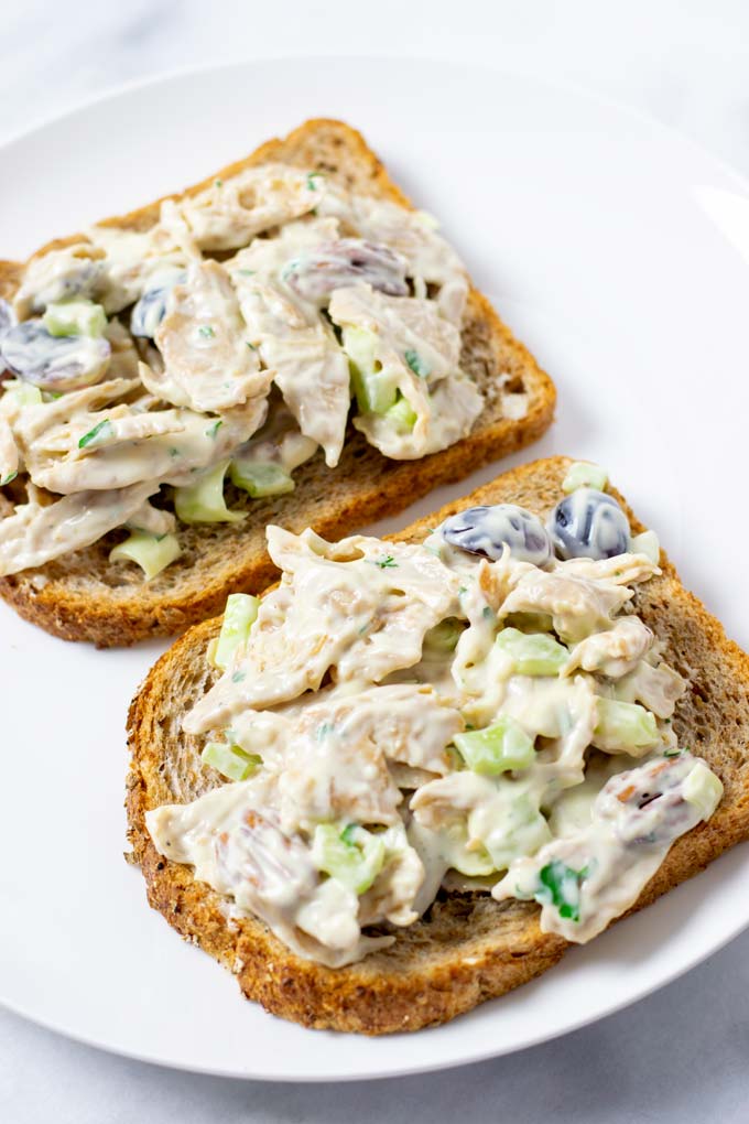 A plate with two sandwiches with Chicken Salad.