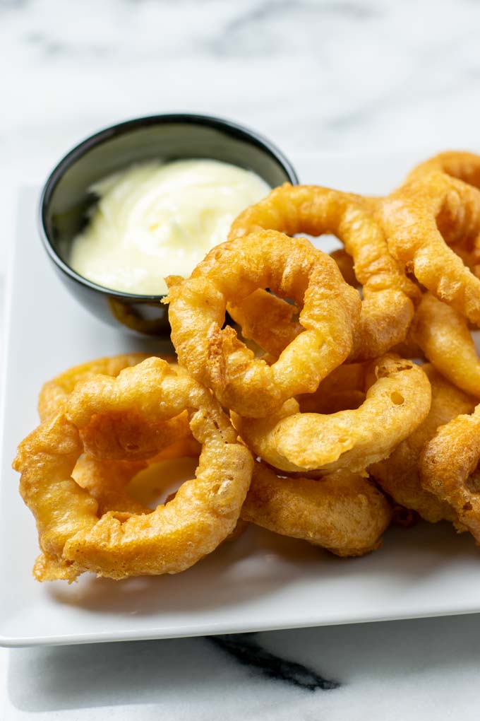 Closeup of a large serving of Onion Rings.