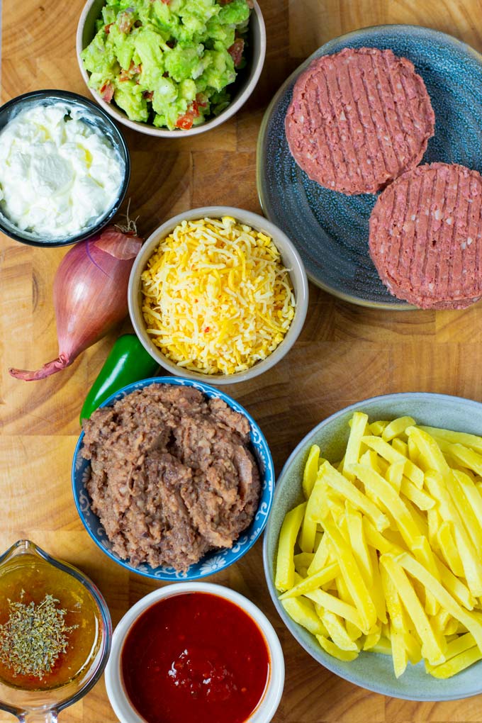 Ingredients for making the California Burritos are collected on a wooden board.