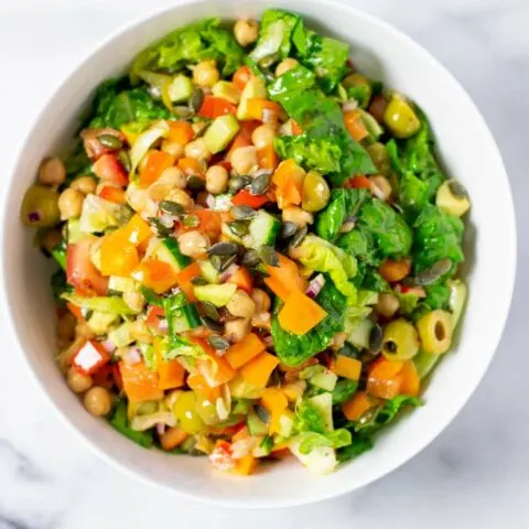 Top view of a white serving bowl with the Chopped Salad.