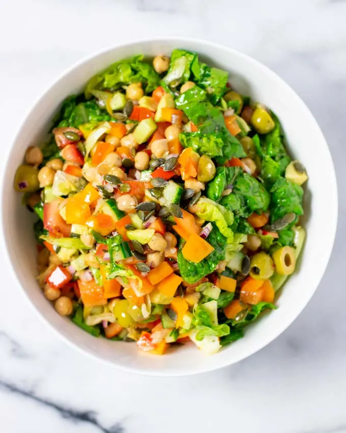 Top view of a white serving bowl with the Chopped Salad.