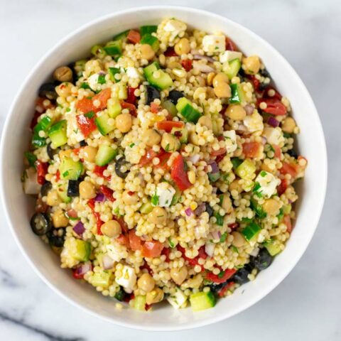 Top view of a white serving bowl filled with the Couscous Salad.