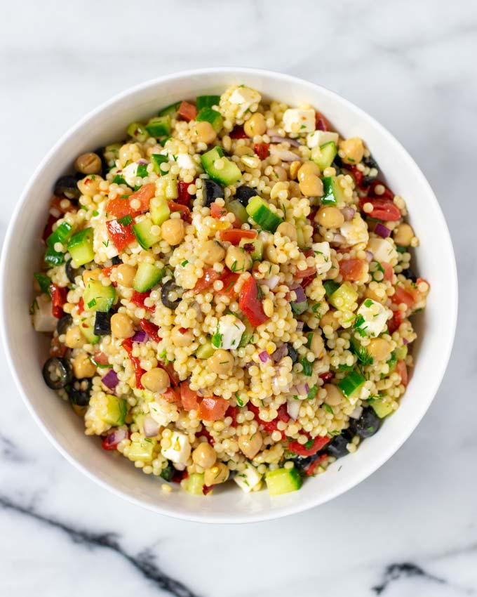 Top view of a white serving bowl filled with the Couscous Salad.