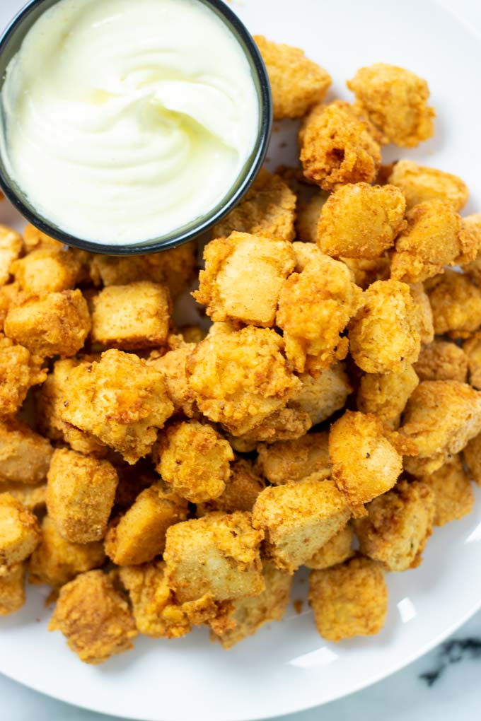 Top view on a portion of the Popcorn Chicken on a large plate.