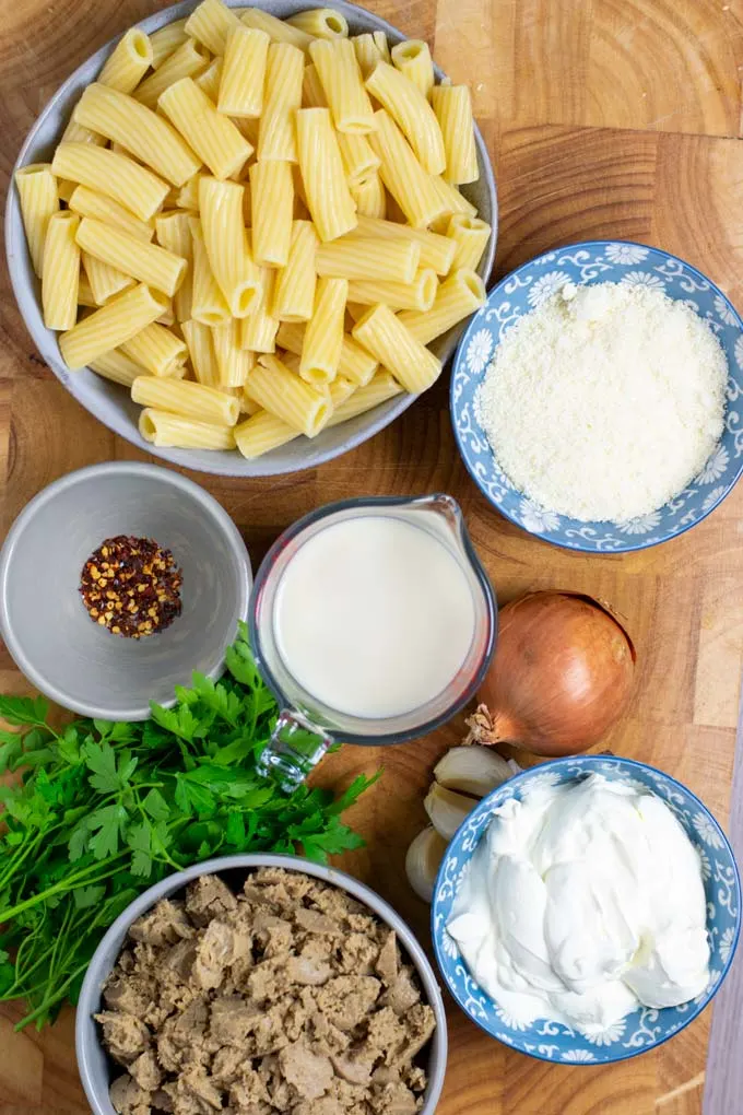 Ingredients for the Sausage Pasta are assembled on a wooden board.