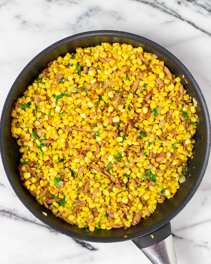 Top view of the pan with the Fried Corn, mixed with bacon and fresh cilantro.