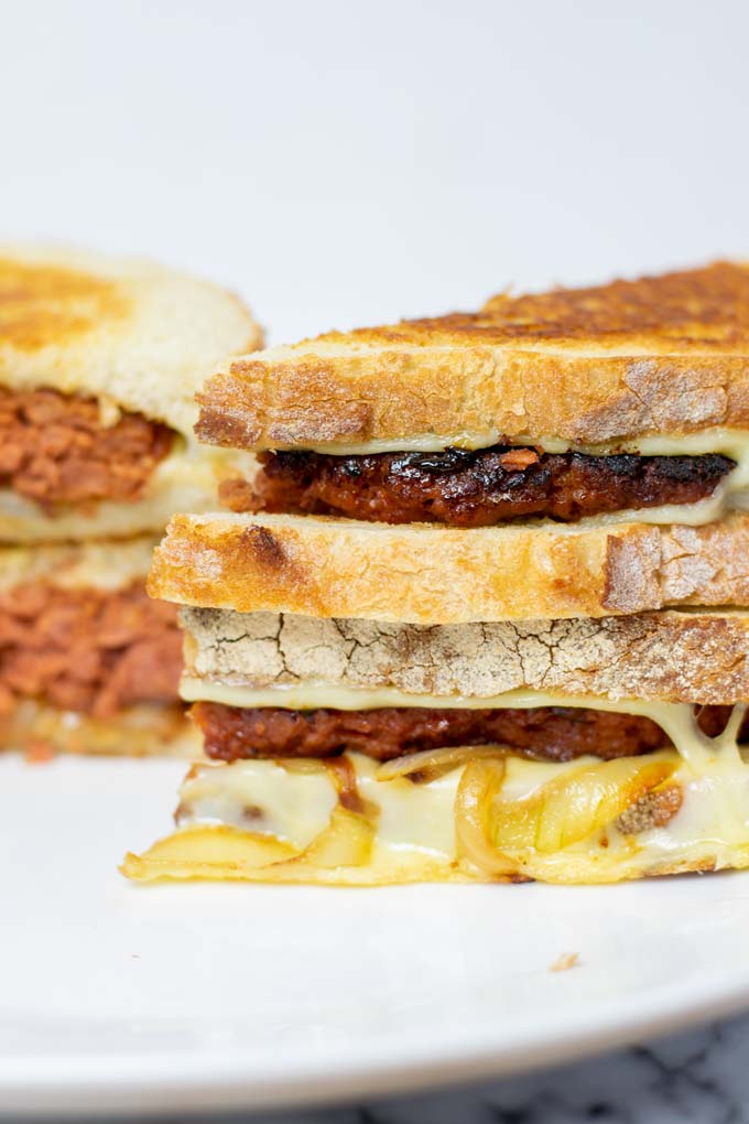 View of the stack of the Patty Melt with melted cheese and caramelized onions coming out.