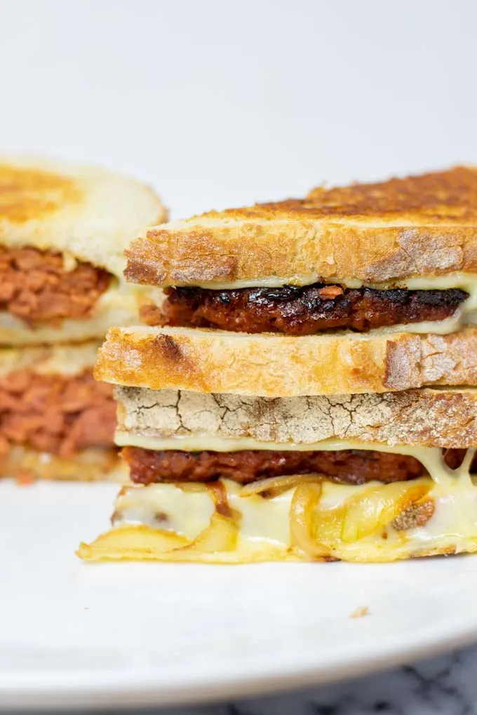 View of the stack of the Patty Melt with melted cheese and caramelized onions coming out.