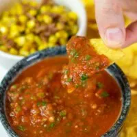A chip is dipped into the Restaurant Style Salsa.