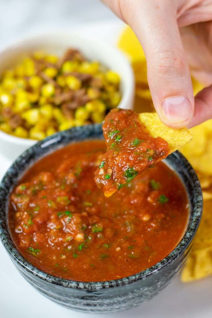 A chip is dipped into the Restaurant Style Salsa.