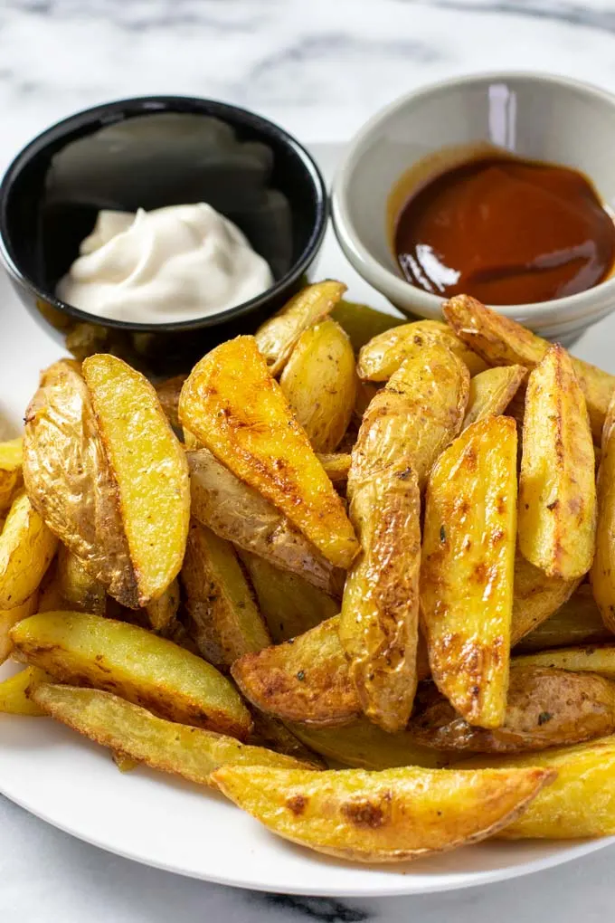 A large portion of the Steak Fries is served with mayonnaise and ketchup.