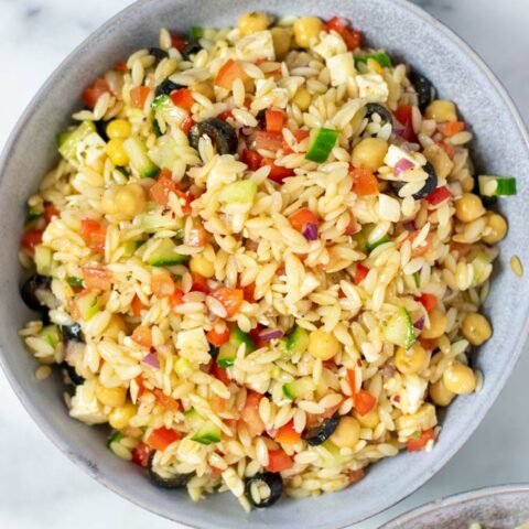 Top view on one serving bowl full of the Orzo Salad.