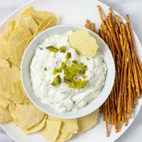 Top view of Pickle Dip served with potato chips and pretzels.