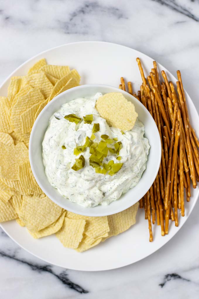 Top view of Pickle Dip served with potato chips and pretzels.