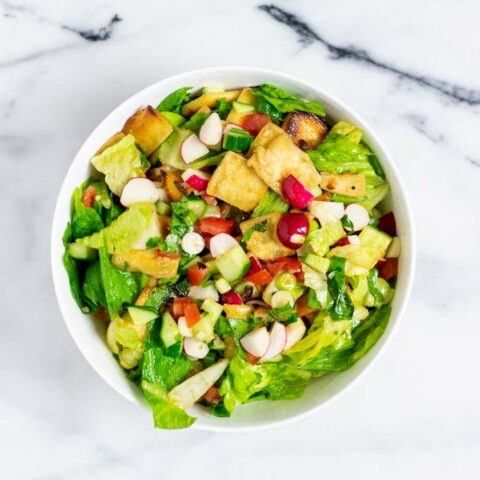 Top view of a white serving bowl with the Fattoush Salad.