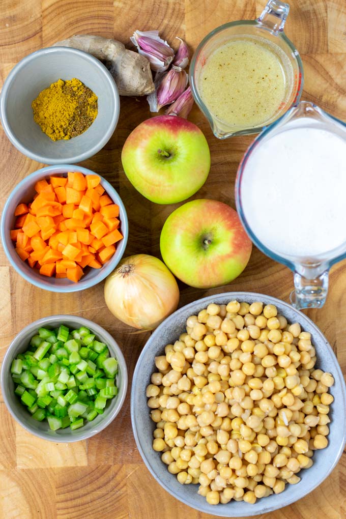 Ingredients needed to make the Mulligatawny Soup are collected on a wooden board.