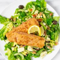 Salmon Salad is garnished with fresh lemon.