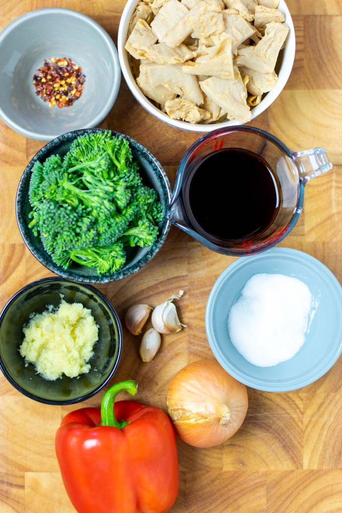 Ingredients needed to make Chicken Stir Fry are collected on a board.