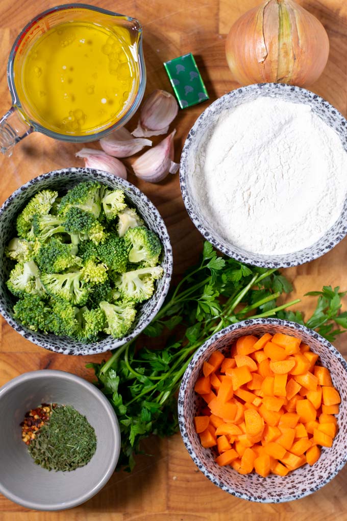 Ingredients needed for Dumpling Soup on a wooden board.