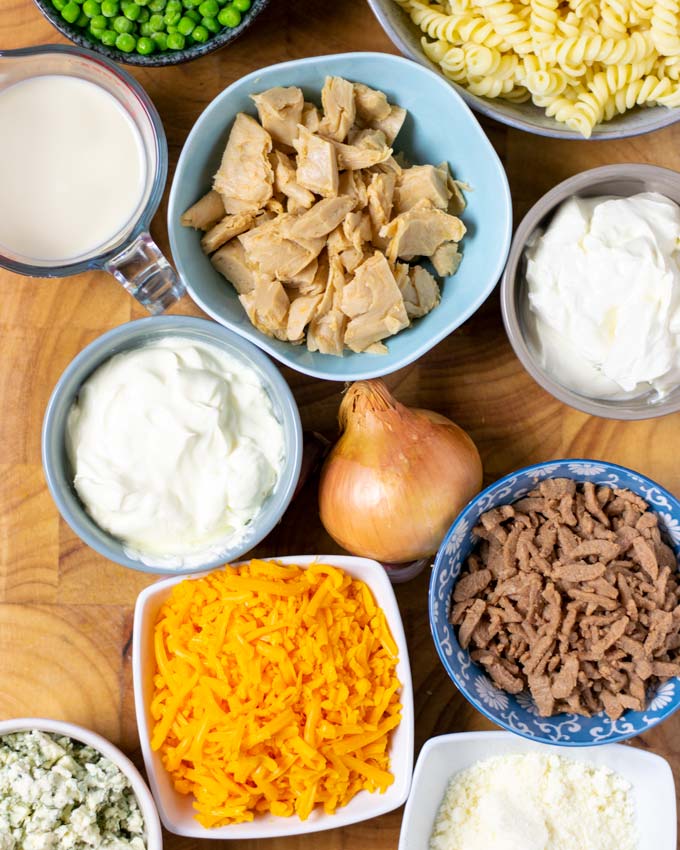 Ingredients for the Pasta Bake are assembled on a wooden board.