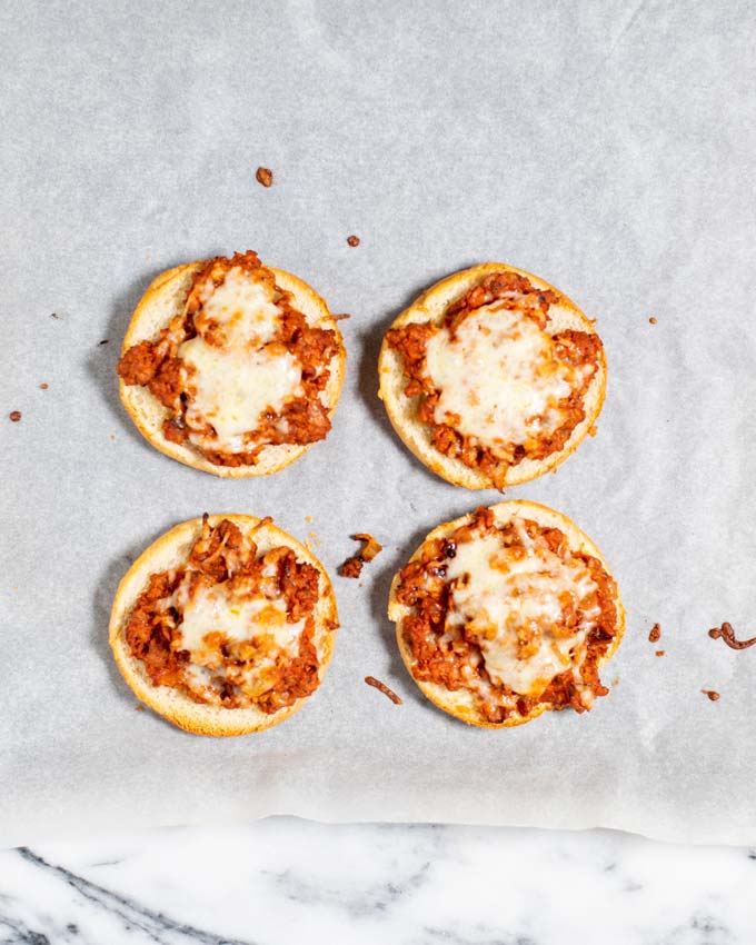 Top view of Pizza Burgers on a baking sheet as they come out of the oven.